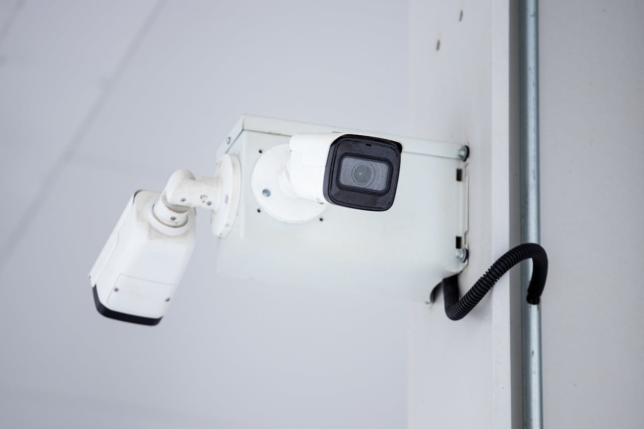 pexels-photo-13422379 A close-up shot of a modern, mounted surveillance camera highlighting security and surveillance.